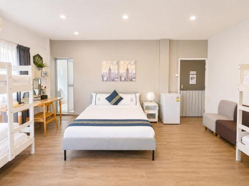 a bedroom with a bed and two bunk beds at K2 Guesthouse in Singapore