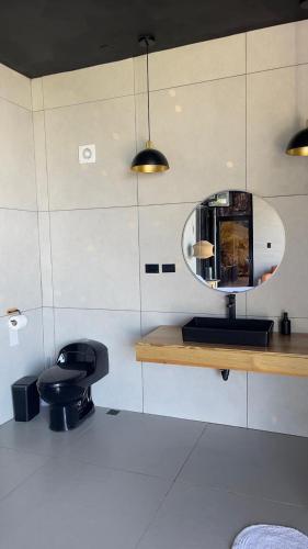 a bathroom with a mirror on a counter and a stool at AGV II Cayo View in Monte Rojo