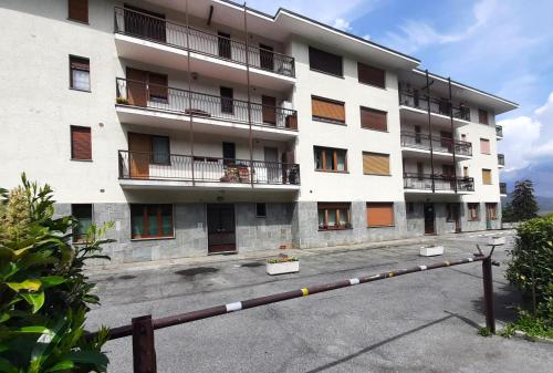 a large white apartment building with a lot of windows at Casa Pioda in Chiomonte
