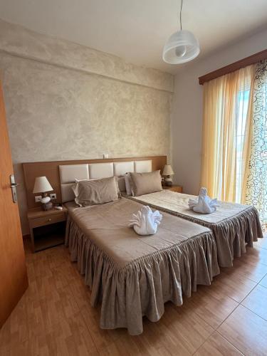 a bedroom with a large bed with towels on it at Anestis House in Anaxos