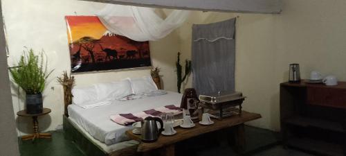 a bedroom with a bed with a sewing machine next to it at Antique Lodge in Arusha