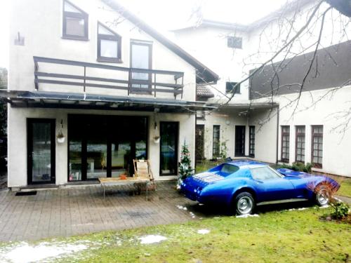 a blue car parked in front of a house at Vilnius Luxury Apartment 3 in Vilnius