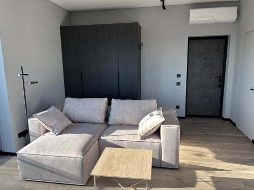 a living room with a couch and a table at Bavaro apartments 4 in Ivano-Frankivsk