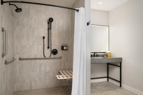 a bathroom with a shower and a sink at The Lantern Hotel Columbia in Columbia
