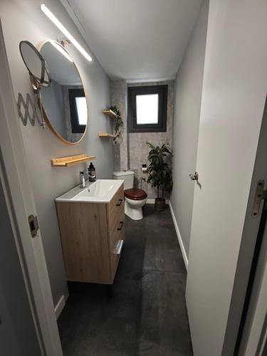 a bathroom with a sink and a toilet and a mirror at Sitges Casablanca in Sant Pere de Ribes