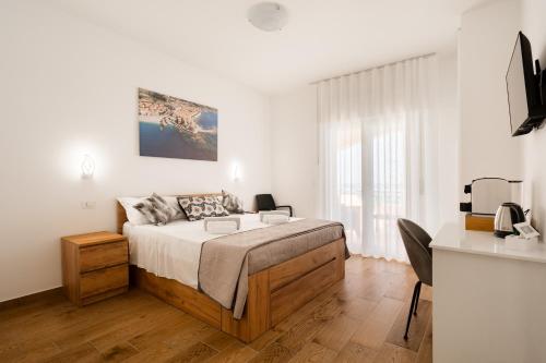 a bedroom with a bed and a desk in it at Dimora dei Cedri in Santa Maria del Cedro