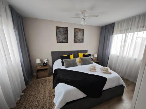 a bedroom with a large bed with yellow and black pillows at Sitges Casablanca in Sant Pere de Ribes