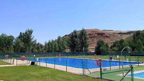a large swimming pool with a fence around it at Casa Rural Villa Huerta in Santa María de Huerta