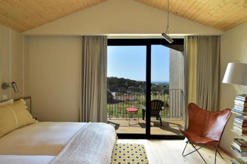 a bedroom with a bed and a view of a balcony at Dream Guincho in Cascais