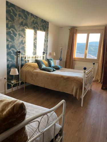 a bedroom with a large bed in a room at Maison de Coco in LʼÉpine
