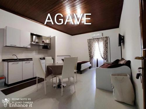 a kitchen and a living room with a table and chairs at Tropea Travel's House in Tropea
