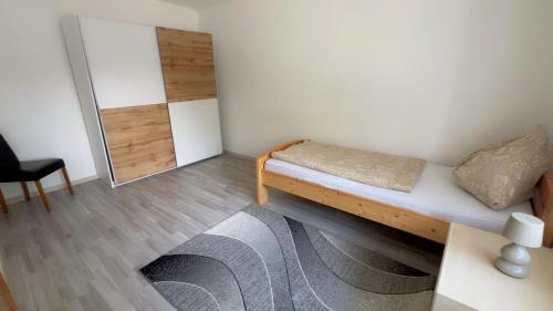 a small room with a bed and a mirror at Ferienwohnung Aiubi in Attnang-Puchheim