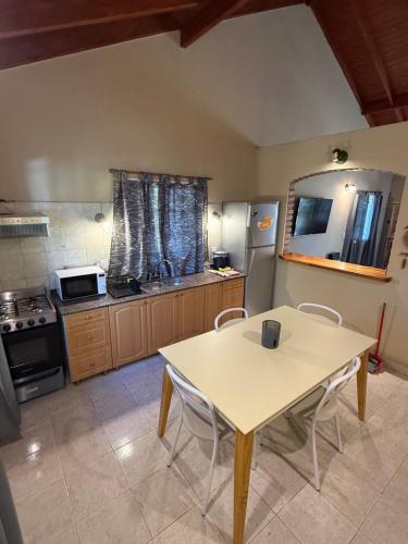 a kitchen with a table and chairs in a room at Casa Guemes in Merlo