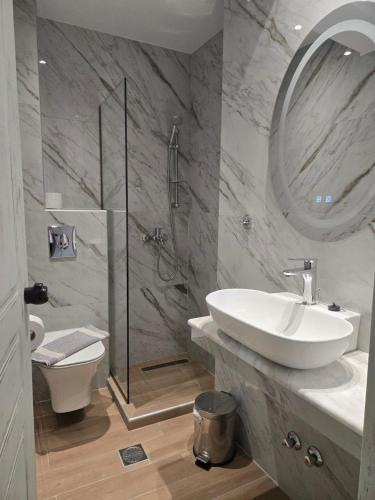 a bathroom with a toilet and a sink and a shower at Nikis studios in Skala Sotiros