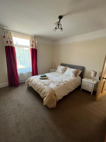 a bedroom with a large bed and a window at Ivanhoe Home from Home in Freshwater