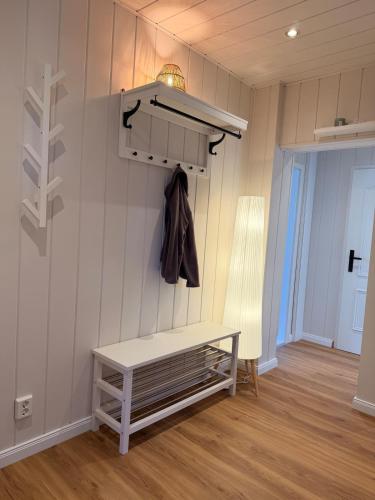a room with a bench and a coat rack at Ferienwohnung Börnecker Landruhe in Börnecke