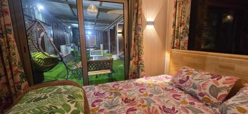 a room with a bed and a view of a yard at Green Discovery's Birds' Nests in Henrietta