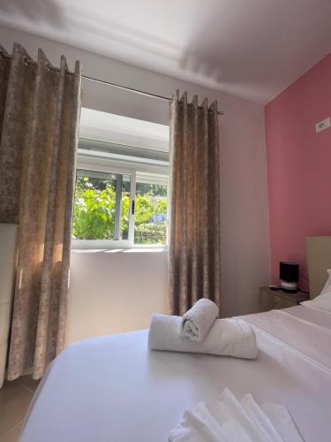 a bedroom with a bed with two towels on it at eljos house permet in Përmet