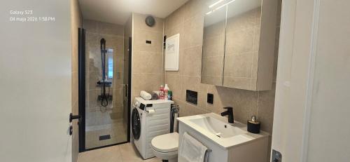 a bathroom with a toilet and a sink at Ramfjord Apartment 2 in Tromsø