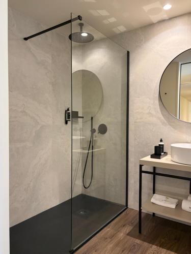 a glass shower in a bathroom with a sink at Quinta Vale de Lobos in Folgosa