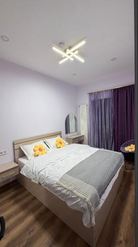 a bedroom with a bed with a ceiling fan at Sunset Telavi in Telavi