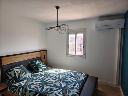 a bedroom with a bed and a ceiling fan at Résidence soleilla in Le Barcarès