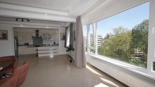 a large room with a large window and a kitchen at Rubens Loft four bedrooms two bathrooms in Antwerp