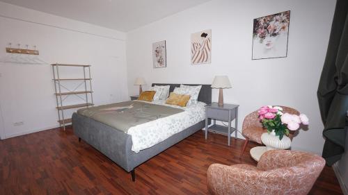 a bedroom with a bed and a chair at Rubens Loft four bedrooms two bathrooms in Antwerp