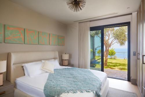 a bedroom with a bed and a large window at Root Redrock Villas Yalıkavak in Yalıkavak