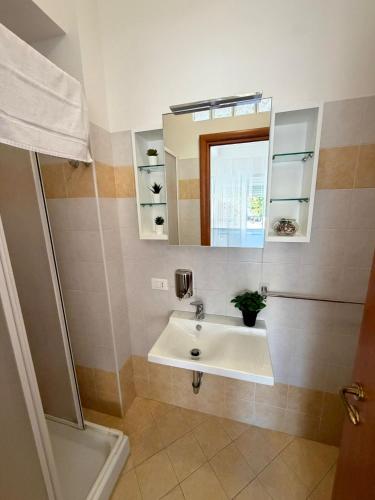 a bathroom with a sink and a mirror at TERRACINA Central Rooms in Terracina
