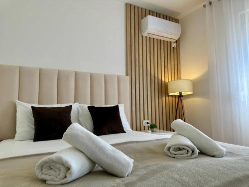 a bedroom with a bed with towels on it at White Hill in Ulcinj