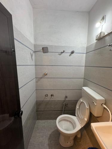 a bathroom with a toilet and a sink at Udupi Shri Krishna Dormitary Bed Space in Udupi