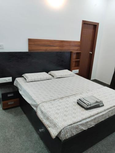 a bed with two pillows on it in a room at Relaxing Villa in Mysuru! in Mysore