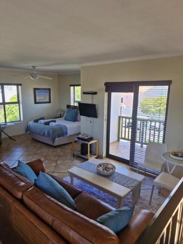 a living room with a couch and a bed at Beachway on Golden Mile in St. Helena Bay
