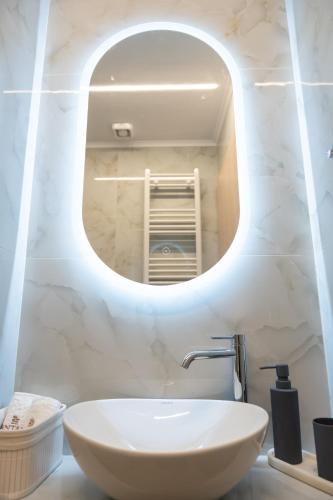 a bathroom with a white sink and a mirror at Antaia 1 in Nafplio
