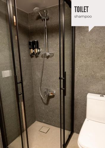 a shower stall in a bathroom with a toilet at Domaine De Faraya F2 in Nab‘ al Maghārah