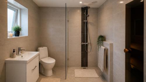 a bathroom with a shower with a toilet and a sink at Pärnu Saunamaja saun, aed, mere lähedal ja tasuta parkimine in Pärnu