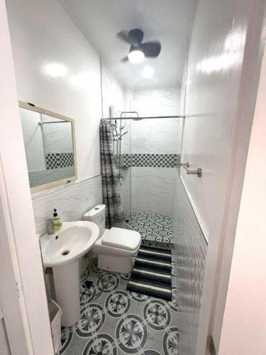 a bathroom with a shower and a toilet and a sink at Villa Trajano Resort in San Antonio