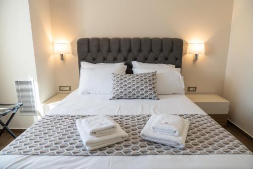 a bedroom with a large bed with two towels on it at Antaia 2 in Nafplio