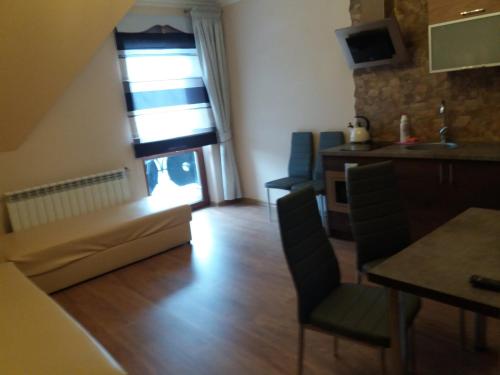 a living room with a table and chairs and a window at Ostrysz in Dzianisz