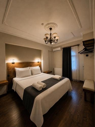 ein Schlafzimmer mit einem großen Bett, auf dem zwei Handtücher liegen in der Unterkunft Hotel Bella in Selçuk