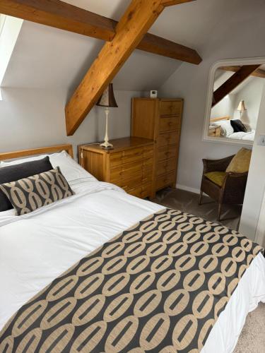 a bedroom with a large bed and a mirror at Shepherds Barn in Beamish