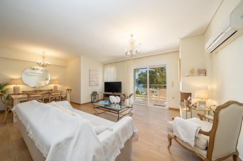 a large bedroom with a bed and a living room at Nefeli Duplex Apartment in Karavomylos