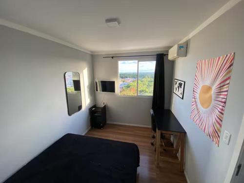 a small room with a bed and a window at Conforto e praticidade perto do aeroporto in Aracaju