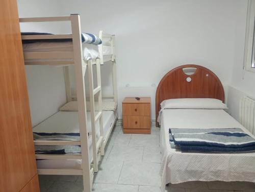a bedroom with two bunk beds and a ladder at albergue bar villamayor in Villamayor del Río