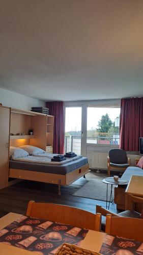 a bedroom with a bed and a large window at Himmelsleiter in Sankt Englmar