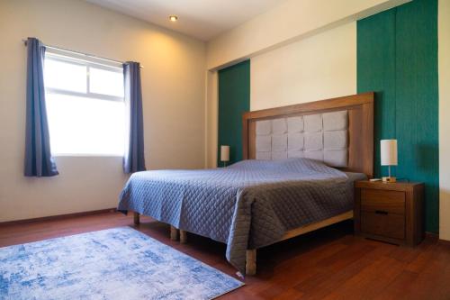 a bedroom with a bed and a window at Santa Elena 400 in Torreón