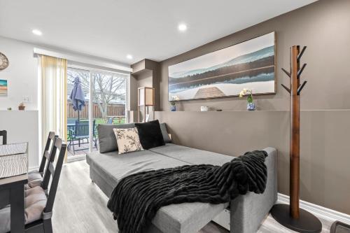 a living room with a bed and a dining room at Entire 5 bedrooms House 14 guests in Barrie