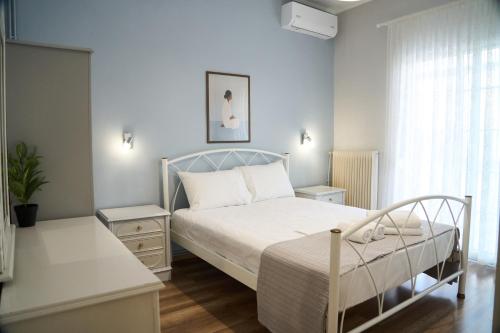 a bedroom with a white bed and a window at Lagoon Dream in Fanari