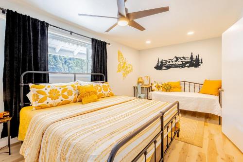 a bedroom with two beds and a ceiling fan at Sunshine Loft in Wrightwood